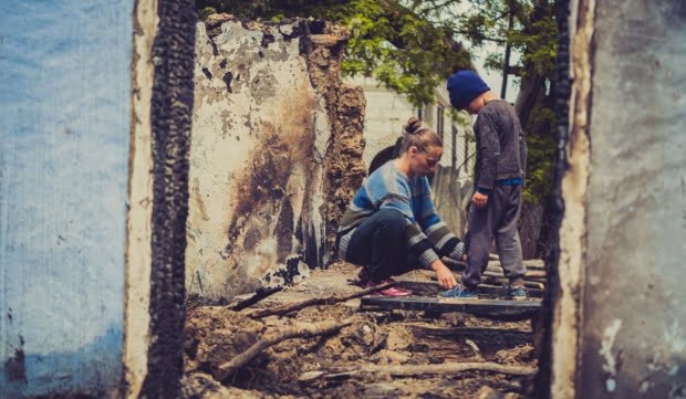 Un copil din Botoșani, cu ochii în lacrimi. A rămas desculț, fără adidași, după incendiul care a distrus casa familiei