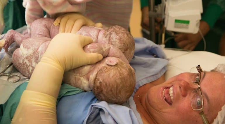 Momentul magic în care o mamă își scoate singură din pântece gemenii, în timpul nașterii prin cezariană